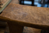 Vintage hand-carved African stool top surface, showing wood grain and patina.