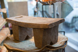 Textured wood surface and long slot of the vintage Senufo hand-carved stool.
