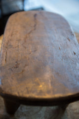 Aged patina and visible hand-carving marks on the Senufo wood stool's surface.