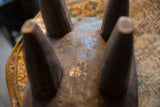 Hand-carved texture and leg joinery on the underside of a vintage Senufo stool.