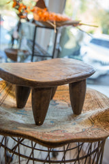 Vintage Senufo wood stool showcasing its sculptural form and weathered patina.