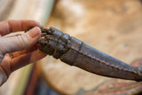 Hand-stitched details and braided leather ties on the vintage African sheath.