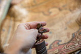 Hand-braided leather loop and coiled top detail of the vintage African sheath.