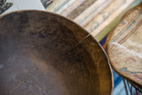 A natural crack and rustic texture inside a vintage handmade African bowl.