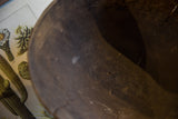Aged texture and a visible crack on the dark interior of a wooden bowl.