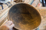 Dark, textured interior of the vintage African wooden bowl with visible aged cracks.
