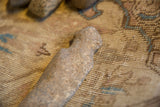 The hand-hewn shape and pitted surface of an ancient African stone weapon.