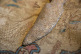 The rough, hand-hewn surface and tapered edge of the primitive stone weapon.