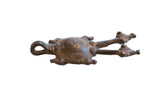 Vintage African double-headed turtle pendant with an aged patina and etched concentric circles.