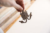 Vintage African double headed turtle pendant, dark textured metal with spiral body.