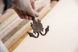 Vintage African double headed turtle pendant with rustic patina, showing curved detail.