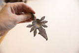 Vintage African pendant held in hand to show its scale and rustic texture.