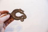 Vintage African chameleon pendant held in hand to show its scale and aged patina.