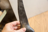 Close-up showing the dark, pitted surface and aged texture of the vintage giraffe.