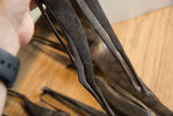 Close-up of the hand-worked, dark metal construction of the vintage giraffe sculpture.