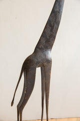 Hand-etched textural patterns on the dark, slender body of a vintage African giraffe.