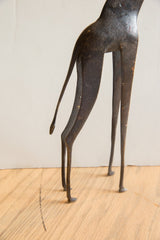 Stylized form of the vintage African giraffe's slender hind legs and tail.