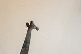 Vintage African giraffe sculpture with a detailed, textured head and neck.