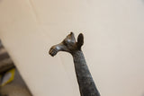 Dark, textured head and neck of vintage African giraffe, showing aged patina.