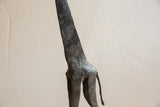 Vintage African giraffe sculpture showing dark, rugged metal texture.