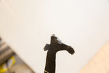 Detail of vintage African giraffe sculpture's dark, textured, organic form.