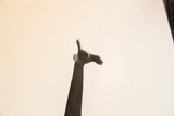 The sculpted head, ears, and horns of a vintage African giraffe figure.