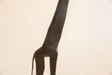 Detail of the vintage African giraffe's dark sculpted torso and tail.