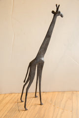 Side view of the vintage African giraffe's elongated neck and slender sculptural body.