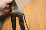 Etched textural surface on the vintage giraffe's hindquarters and long tail.