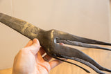 Hand-stamped textural details on the aged metal of a vintage African giraffe sculpture.