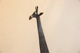 The smooth head and long, textured neck of the vintage African giraffe sculpture.