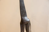 Etched spot-like texture on the neck and back of the vintage giraffe sculpture.