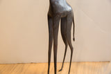 Slender hind legs and textured body of a vintage African giraffe collectible.