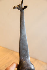 Angled view of the vintage giraffe's head and long, textured neck.