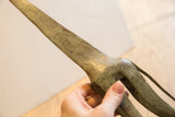 Aged metal patina and texture on the slender neck of a vintage giraffe sculpture.