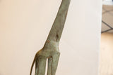 Detailed view of the weathered patina and surface marks on the giraffe's neck.