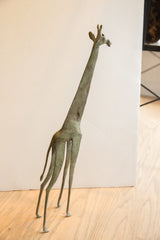 Elegant stance of the large vintage African giraffe collectible, viewed in profile.