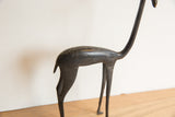 Profile view of the vintage gazelle sculpture showing its dark finish and smooth form.