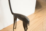 Aged patina on the dark, smooth body of the vintage African gazelle sculpture.