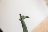 Vintage African giraffe sculpture head and upper neck with weathered green-brown patina.