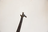 Vintage African giraffe sculpture, dark metal head with textured neck.