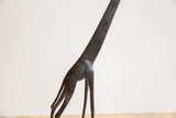 Vintage African giraffe: dark metal body featuring intricate textured patterns.