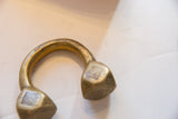 Etched surface markings and aged gold patina on the antique bronze Tuareg cuff.