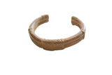 Antique African bronze cuff bracelet with a rich, dark patina and etched striped details.