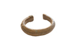 Antique African bronze bracelet with a ridged texture and time-worn patina.