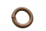 Circular antique African copper alloy bracelet with a textured, time-worn patina.