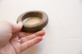 Antique African copper alloy bracelet held in hand to show its substantial form and patina.