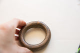 Close view of the hand-forged seam on a weathered antique copper bracelet.