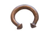 Antique African copper alloy cuff bracelet with a dark, time-worn patina and flared ends.