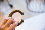Side view of the antique African cuff showing its incised marks and patina.